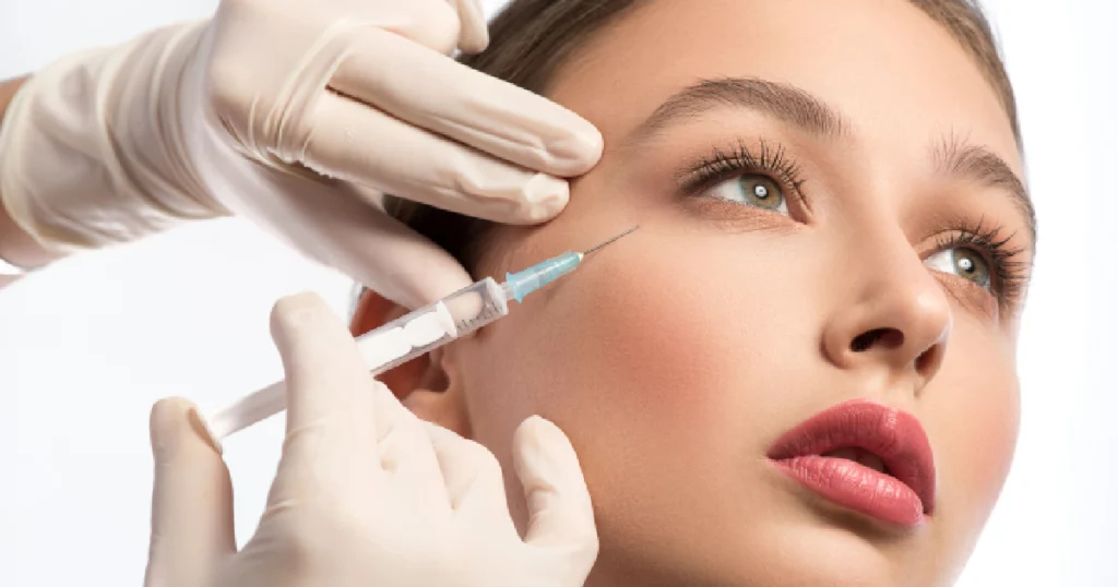 Current image: Woman receiving a Sculptra injection in the cheek by a professional, highlighting non-surgical facial rejuvenation with Sculptra in Tampa, FL.