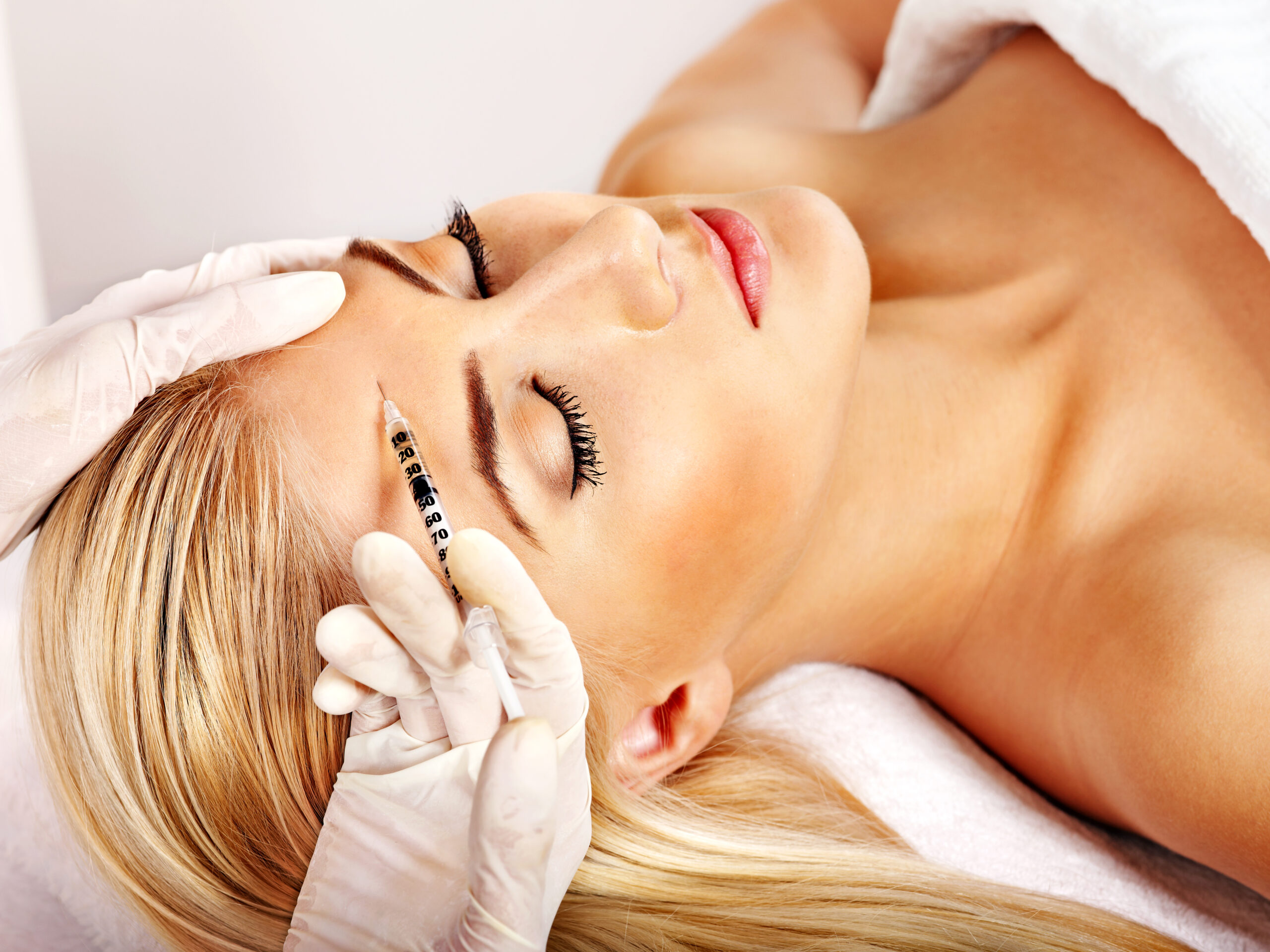 Client receiving Botox injection at Arcanum Aesthetics in Tampa, FL for wrinkle reduction and youthful skin rejuvenation