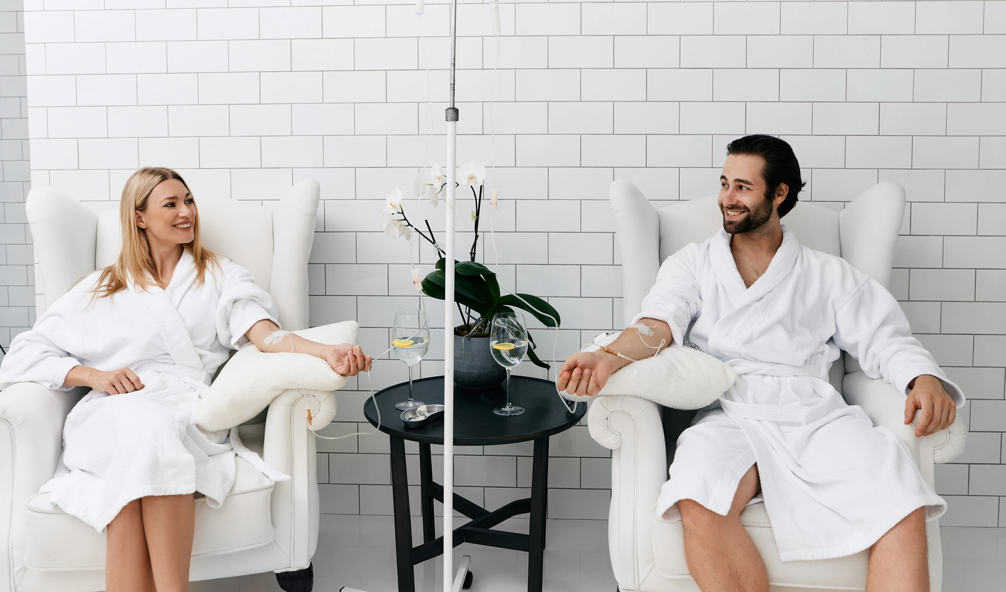 Clients relaxing during IV hydration therapy session at Arcanum Aesthetics Tampa, FL, restoring wellness and hydration