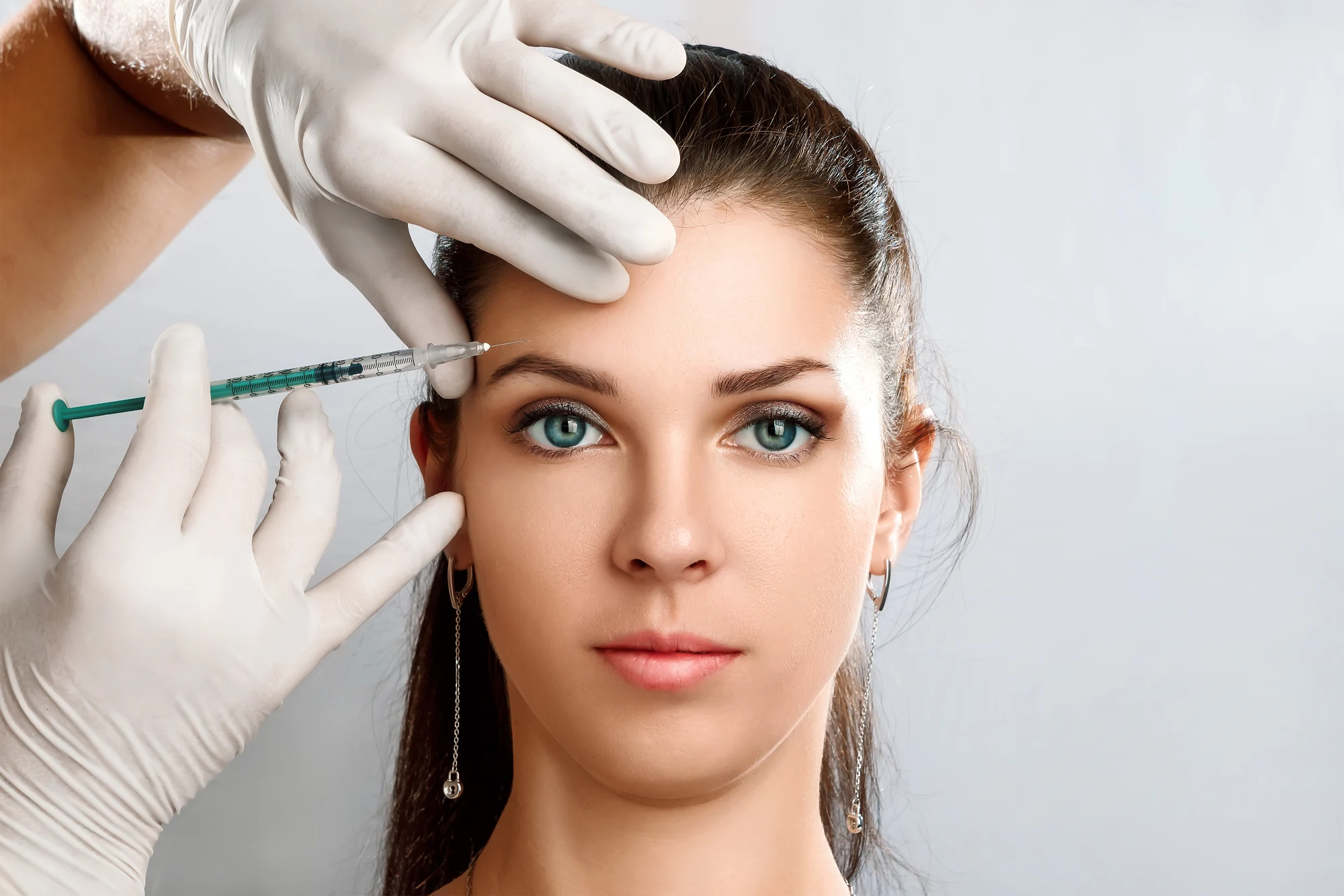 Client receiving Xeomin injection at Arcanum Aesthetics in Tampa, FL, for wrinkle reduction and youthful skin rejuvenation